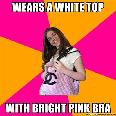 Wears a white top - with a bright pink bra so you can see it