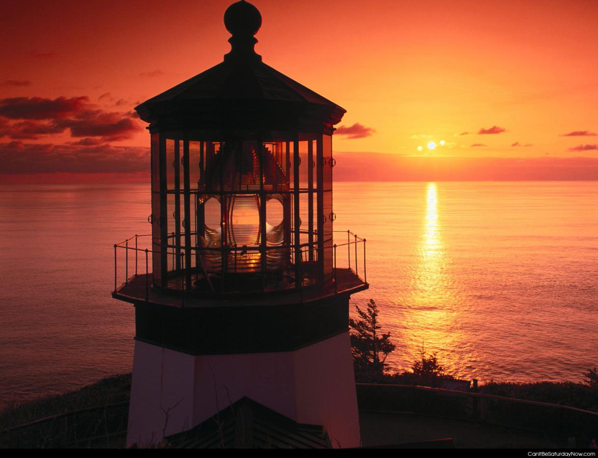 Lighthouse sunset - classic lighthouse with a red sunset